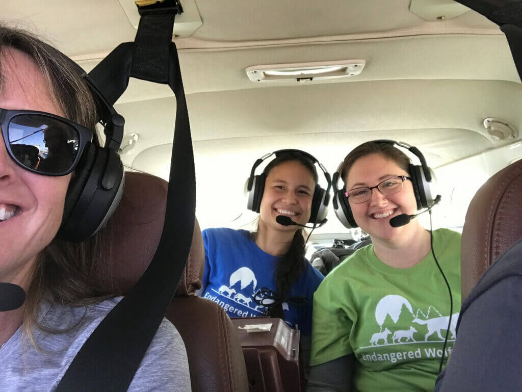 Endangered Wolf Center team Sarah Holaday and Kim Rutledge on Arizona Game &Fish plane flying to wild dens