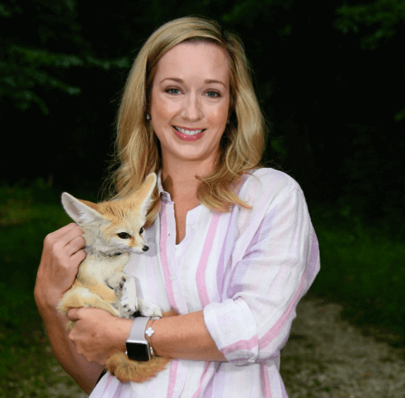 Virginia Busch smiles while holding Daisy the fennec fox.